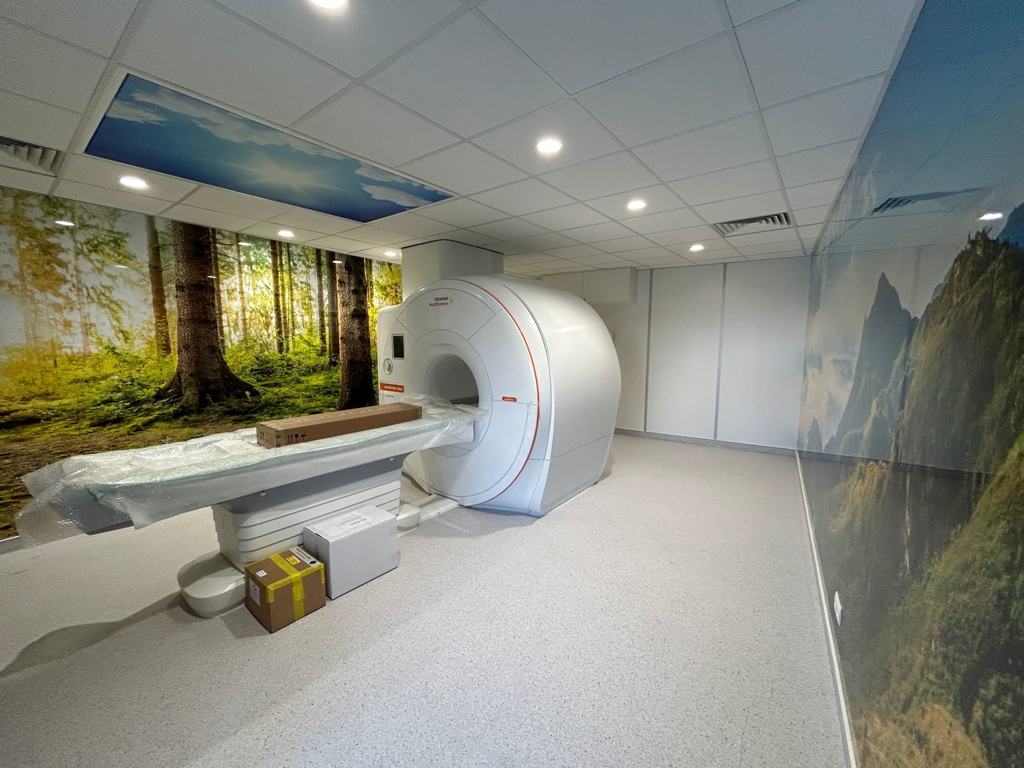 Modern MRI room with scenic wallpaper, stunning lighting, and advanced RF shielding solutions by MedXsolution.